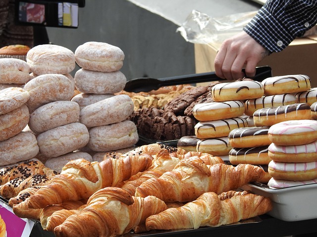 A table with multiple kinds of donuts and croissants